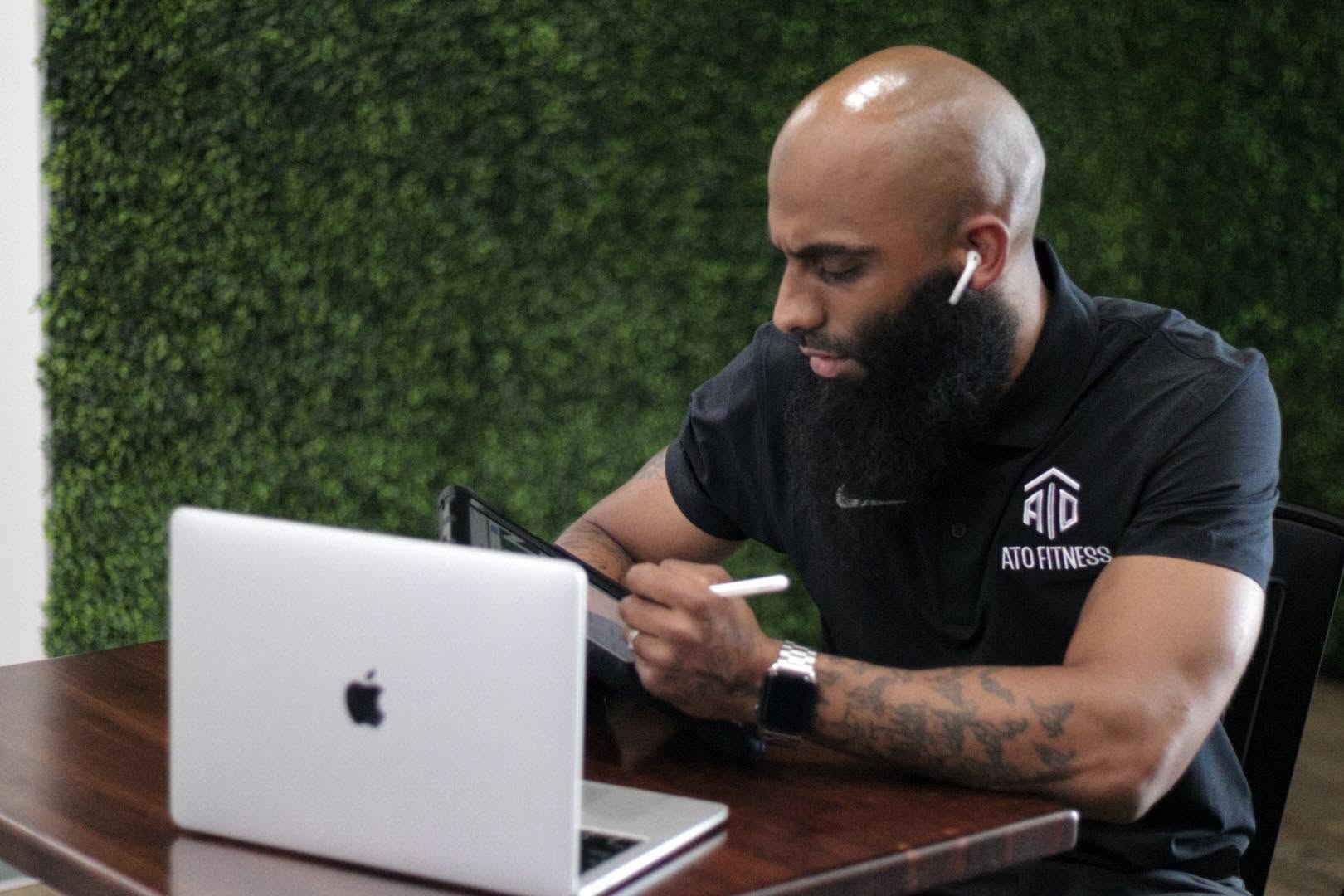 Coach T programming on his laptop